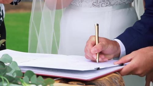 Groom signing the official Wedding Certificate - close up