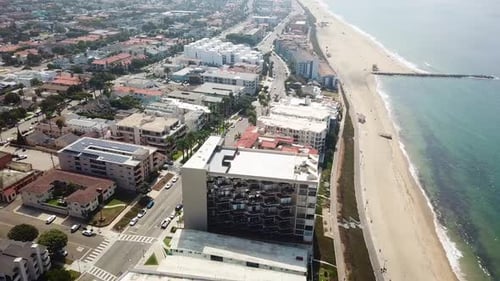 Luxury waterfront apartment hotels and buildings in Redondo Beach, California. Aerial flyover shot.
