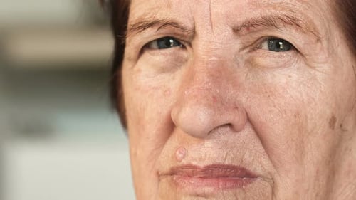 sad serious old woman staring at camera,close up