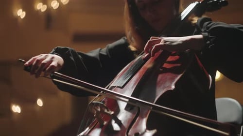 Cellist on Scene of Philharmonic Hall Concert of Classical Music Closeup View of Cello and Bow