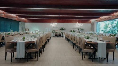Spacious wedding banquet hall setup with elegant tables and natural decor