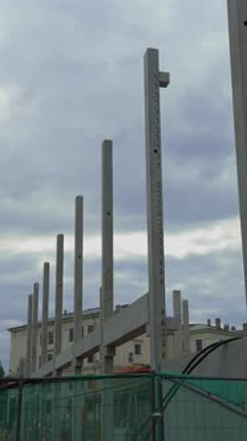 Concrete Pillars are Currently Under Construction Standing Tall Against a Backdrop of a Cloudy Sky