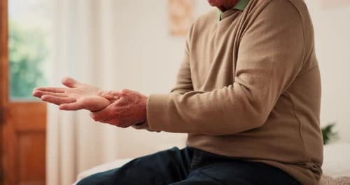 Senior man with disability, hands and pain of wrist from parkinson, carpal tunnel