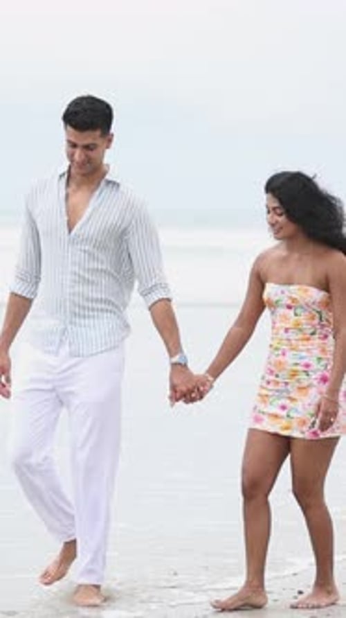 Romantic Young Couple Walking on the Beach