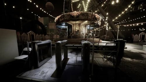 Spinning Carousel With Decorative Lights At Night Fair