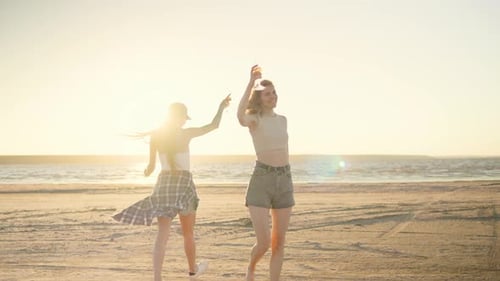 Two Good Friends Enjoying a Beautiful and Serene Sunset Walk Together on the Beach Embracing the