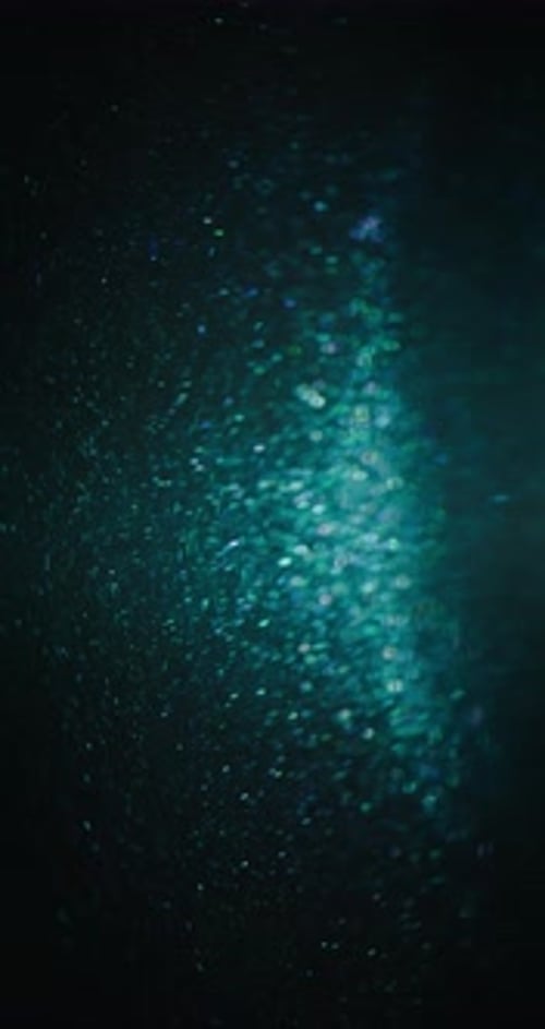 Abstract Background of Sparkling Blue and Green Particles