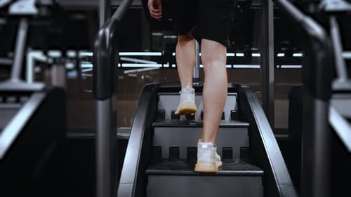 Fitness man trains in a modern gym