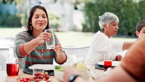 Family Mealtime Outdoors with Food and Drinks