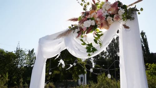 Decorated Wedding Archway with Flowers and Lights