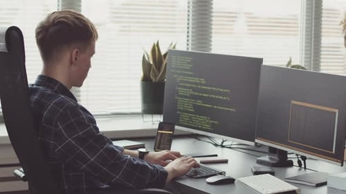 IT Student Writing Program Code on Computer