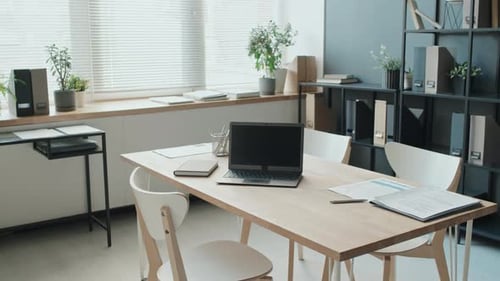 Review Of Light Empty Office With Opened Laptop On Table