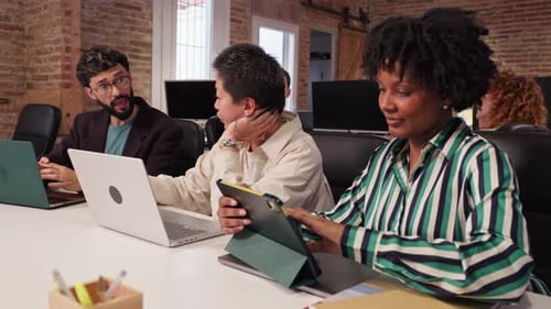 Coworkers Collaborating on Project in Modern Office