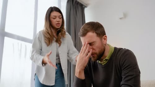Woman Arguing With Distressed Man at Home
