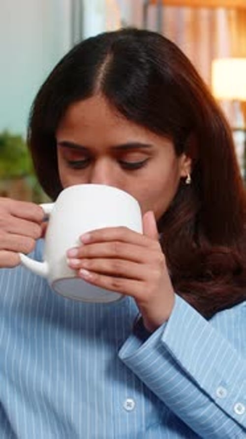 Woman Enjoys Hot Beverage at Home, Close Up