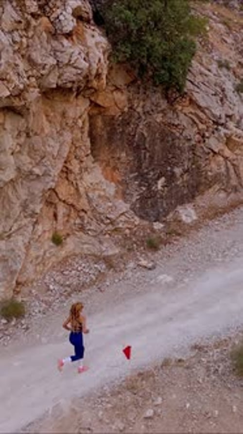 Female Athlete Running in Canyon