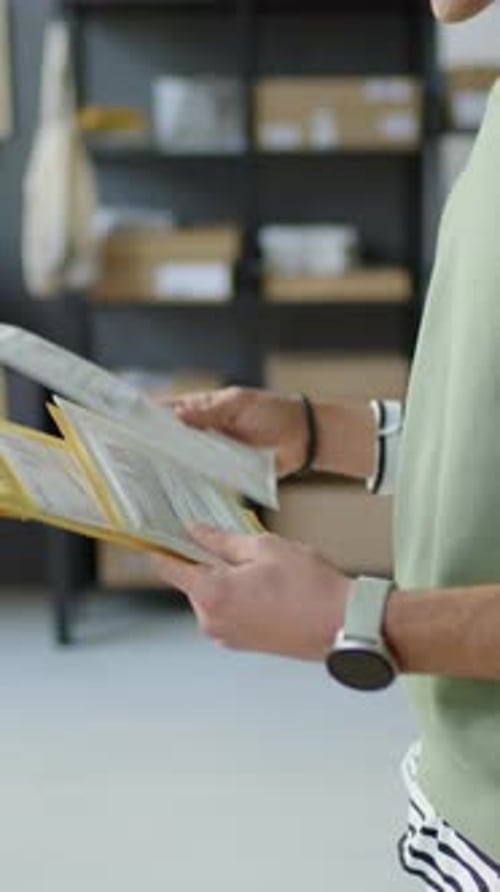 Person Passes Stack of Documents to Another