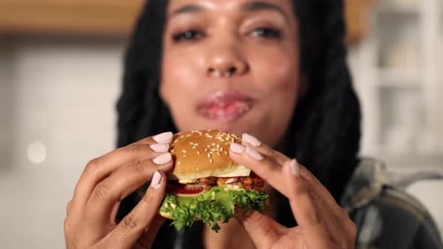 Closeup View of Delicious Juicy Hamburger in Hands of Black Woman Fast Food Young Adult African