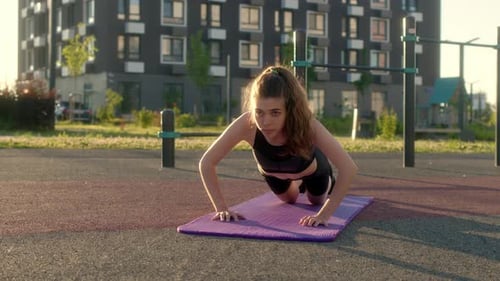 Woman Doing Push-ups in Urban Outdoor Workout Area