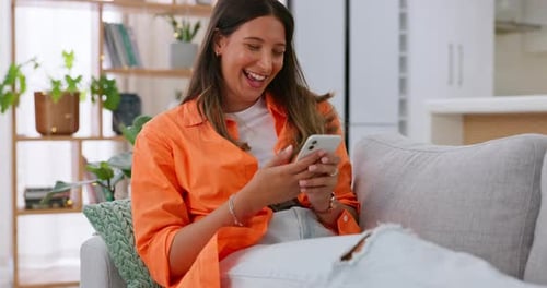 Woman, phone and laughing for funny joke, meme or social media post relaxing on living room sofa