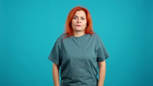 Woman Standing Still Looking Sad in Studio