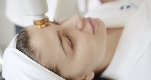 Woman Receives Rejuvenating Facial Treatment at Spa