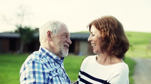Senior couple embracing in a scenic countryside