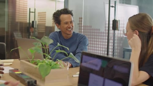 Cheerful Colleagues Talking in Office Meeting Room