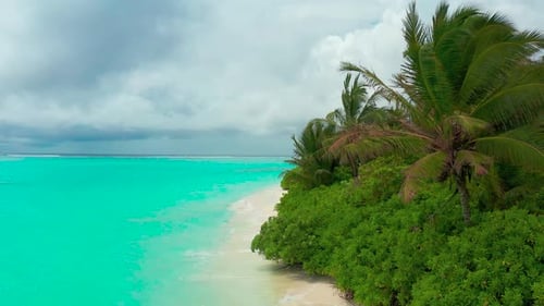 Aerial view on Tropical island in cloudy weather in Maldives.