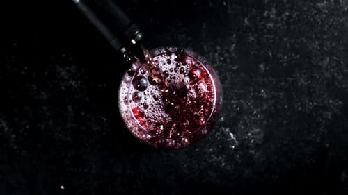 Red Beverage Being Poured Into Glass from Above