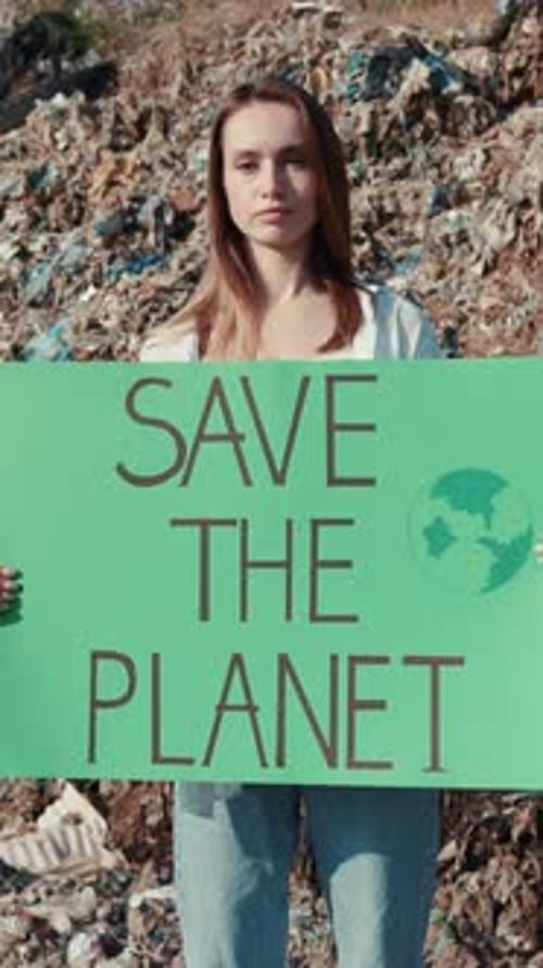 Serious Woman Holding Save the Planet Sign
