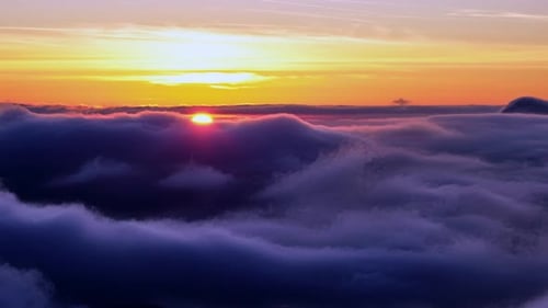 Aerial View of Sunrise Above a Sea of Clouds