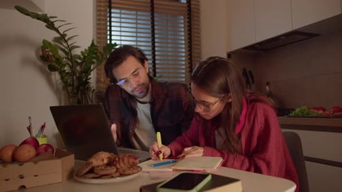 Man and Woman Working Together in Home Kitchen