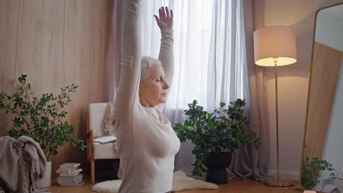 Senior Woman Practicing Yoga in Living Room