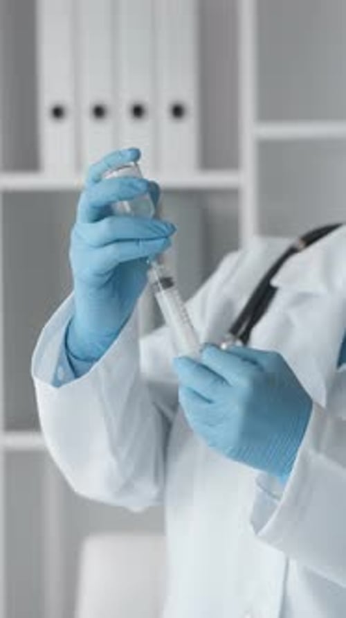 A Doctor Concentrates on Drawing a Drug Into a Syringe Reflecting a Balanced Approach to Medical