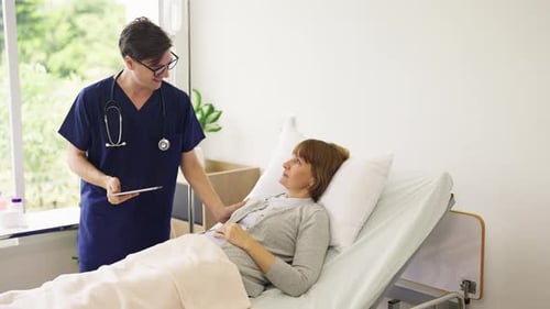 High view Young doctor use tablet to discuss about the plan of disease treatment with senior woman