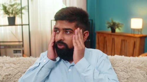 Indian Man Holds Head Eyes Wide Panic Overload Stress Reaction Severe Pressure Mental Strain Indoors