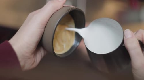 Foamy Milk Poured Into Coffee Cup Close Up