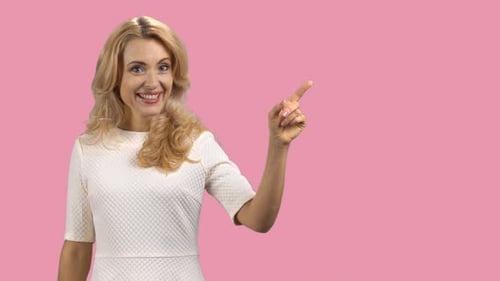 Blonde Woman Smiling and Pointing to the Right