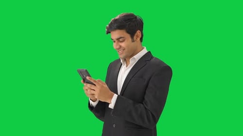 Happy Indian manager talking to someone on text Green screen
