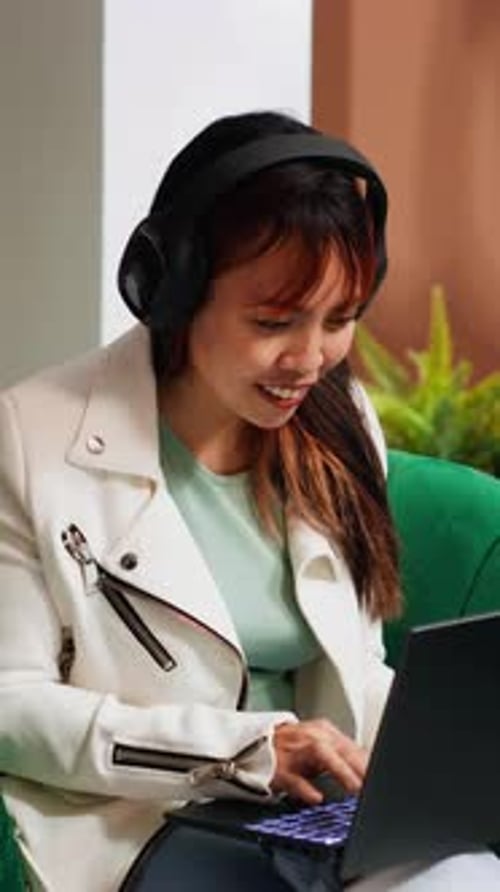 Vertical Video Hotel Guest Watching Movies on Laptop in Lounge Area