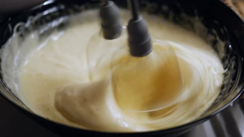 Whipping Cream Using an Electric Mixer in a Bowl for Various Recipes