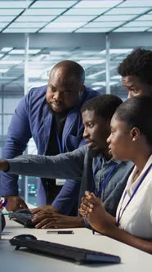 Vertical Video Teamworking Engineers Talking in Server Room Doing Brainstorming