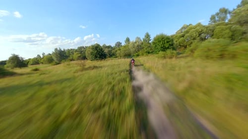 FPV Drone Chasing a Man Riding a Motocross Bike at High Speeds