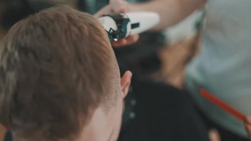 Man Getting a Haircut in a Hair Salon