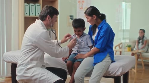 Pediatrician Using Stethoscope to Listen to Sick Kids Breath