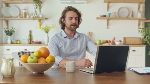 Man Attending Video Call in Bright Kitchen