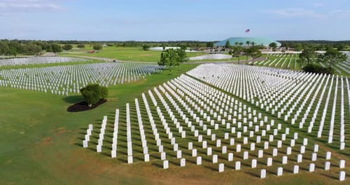 Memorial Day Concept Sarasota National Cemetery with Rows of White Tomb Stones on Green Grass