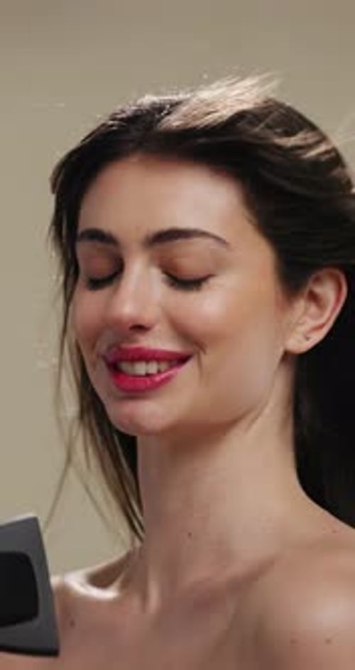 Woman, blowing and hair dryer with smile for grooming, styling or treatment on a studio background