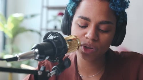 Woman Recording Podcast with Microphone at Desk